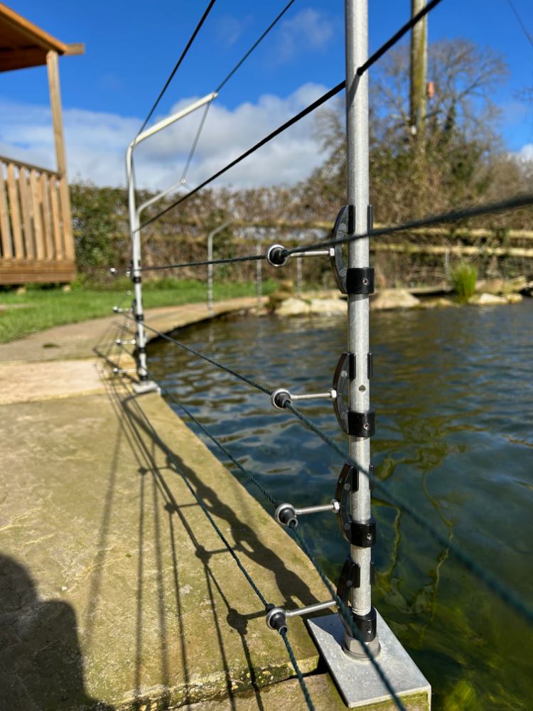 Close up of predator control fencing for pond